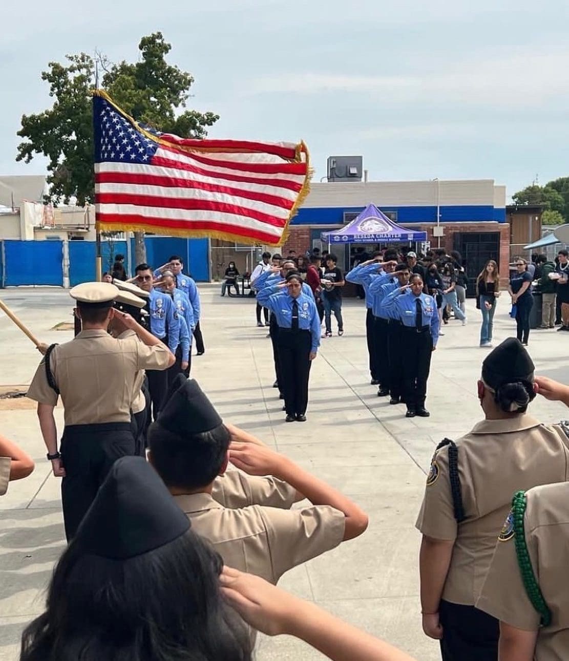 A Group of People in Uniform Standing in Front of a Flag